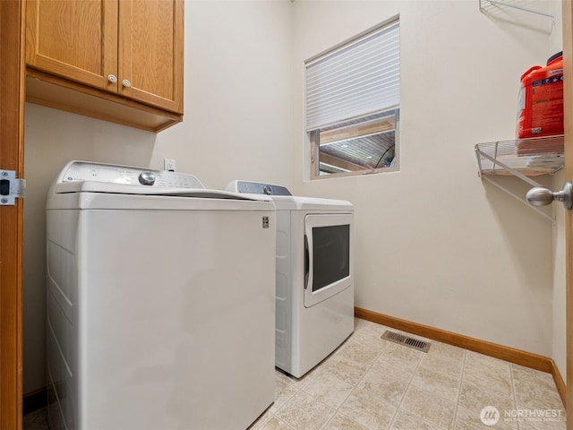 28235 SE 268th St, Ravensdale, WA 98051 - clothes washing area with washing machine and dryer, cabinet space, baseboards, and light tile patterned flooring