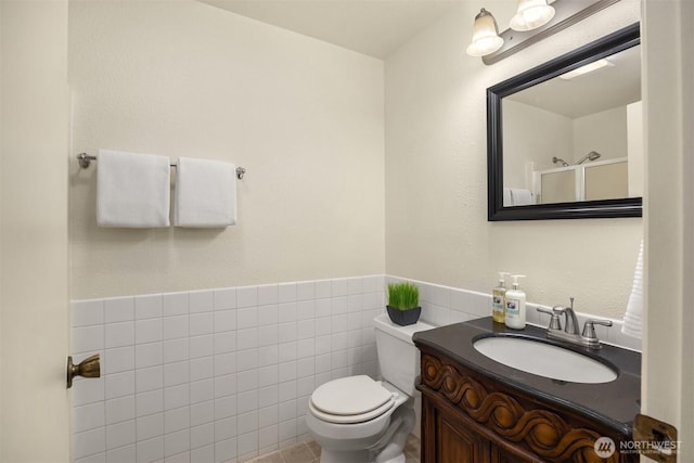 26692 Weaver Ave NW, Poulsbo, WA 98370 - bathroom with toilet, vanity, and tile walls
