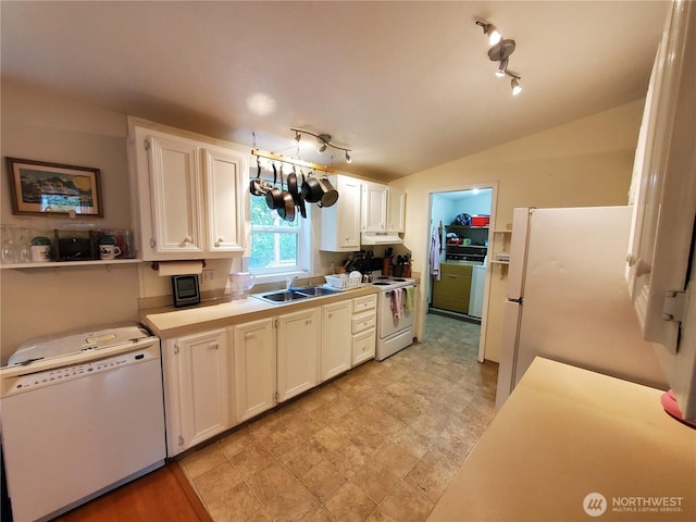 669 Duck Lake Dr NE, Ocean Shores, WA 98569 - kitchen with white appliances, a sink, white cabinetry, lofted ceiling, and light countertops