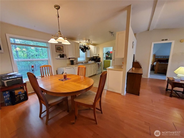 669 Duck Lake Dr NE, Ocean Shores, WA 98569 - dining space featuring light wood-type flooring and lofted ceiling