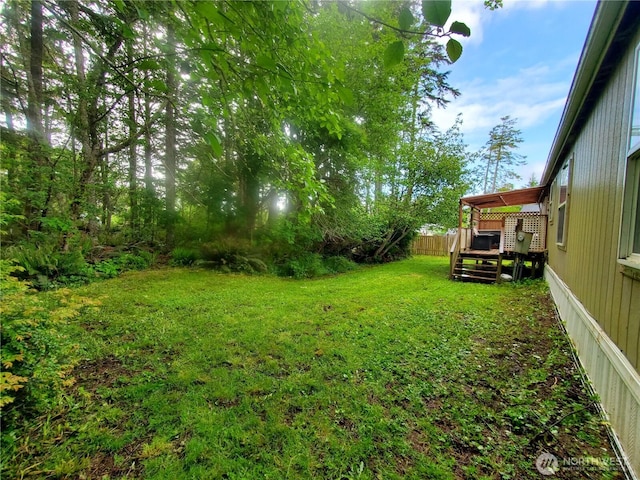 669 Duck Lake Dr NE, Ocean Shores, WA 98569 - view of green lawn with a deck
