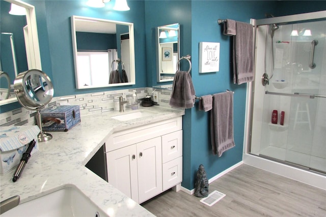 1427 100th St SW Unit 149, Everett, WA 98204 - bathroom featuring backsplash, a shower stall, wood finished floors, and vanity