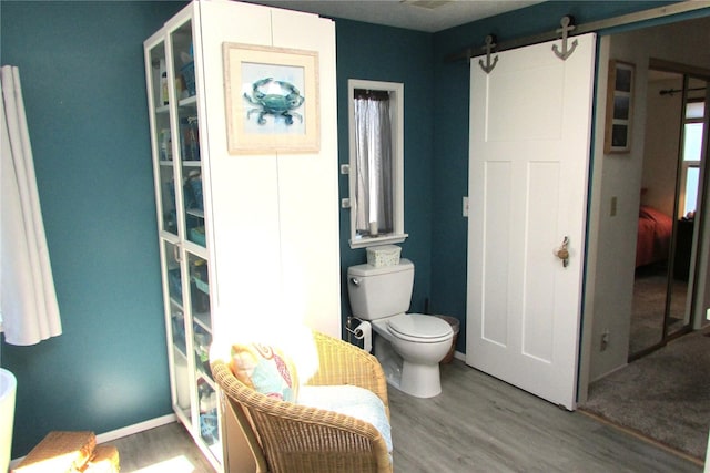 1427 100th St SW Unit 149, Everett, WA 98204 - bathroom featuring toilet, wood finished floors, and baseboards