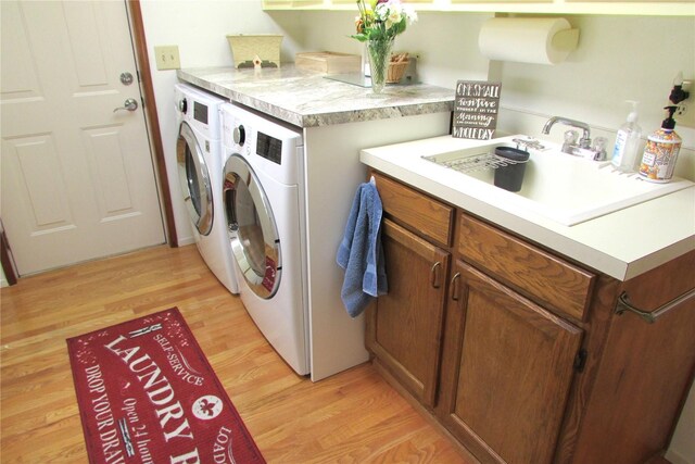 1427 100th St SW Unit 149, Everett, WA 98204 - laundry room with separate washer and dryer, light wood-type flooring, and cabinet space