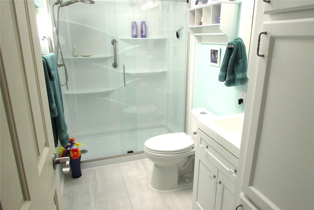 1427 100th St SW Unit 149, Everett, WA 98204 - bathroom featuring a shower stall, toilet, tile patterned flooring, and vanity