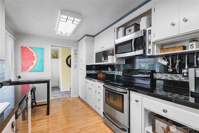 5502 N 21st St, Tacoma, WA 98406 - kitchen with appliances with stainless steel finishes, open shelves, backsplash, light wood finished floors, and white cabinetry