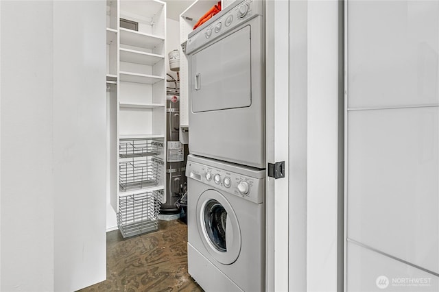 clothes washing area featuring stacked washing machine and dryer