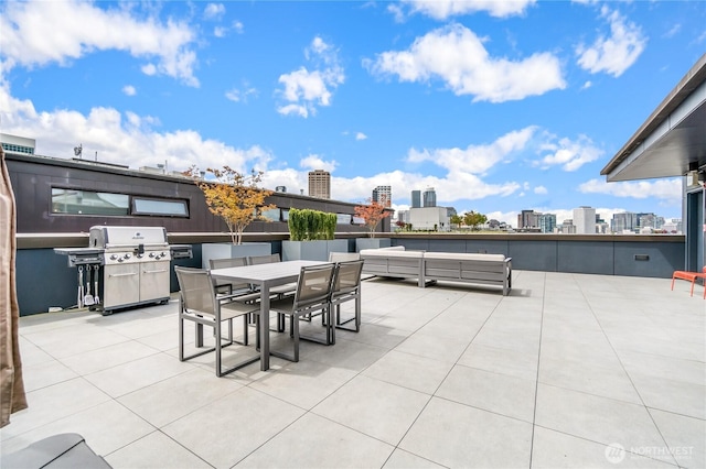 view of patio with a view of city, area for grilling, outdoor dining space, and an outdoor living space