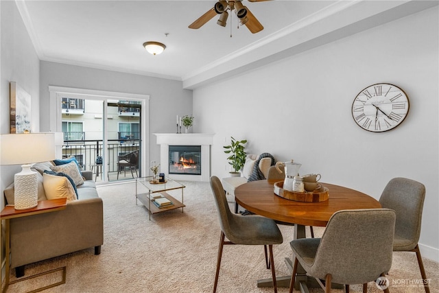 1015 Railroad Ave Unit 415, Bellingham, WA 98225 - living area with light carpet, a ceiling fan, crown molding, a glass covered fireplace, and baseboards