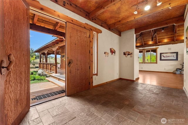 117 Vintin Rd, Carlton, WA 98814 - spare room with stone tile floors, beamed ceiling, baseboards, and rail lighting