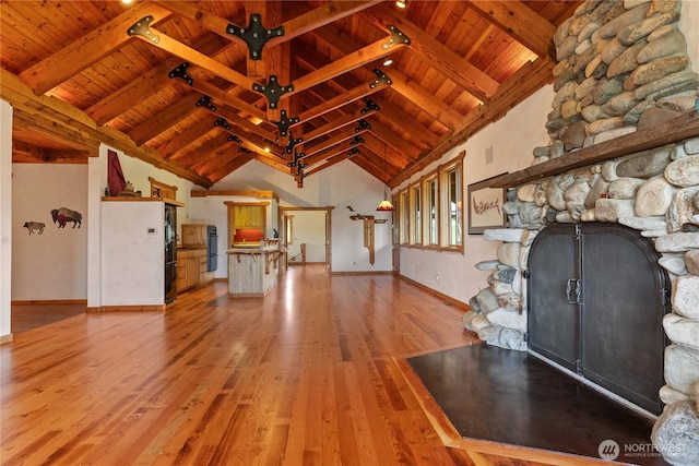 117 Vintin Rd, Carlton, WA 98814 - unfurnished living room with wood ceiling, a stone fireplace, light wood finished floors, beamed ceiling, and baseboards