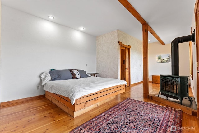 117 Vintin Rd, Carlton, WA 98814 - bedroom with a wood stove, light wood-type flooring, beamed ceiling, and recessed lighting