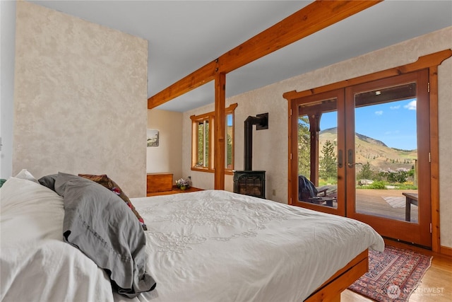 117 Vintin Rd, Carlton, WA 98814 - bedroom featuring multiple windows, access to exterior, french doors, wood finished floors, and beamed ceiling