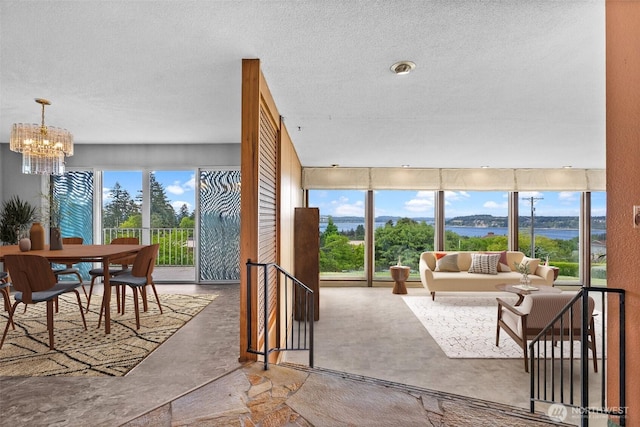 7618 19th St W, Tacoma, WA 98466 - living room featuring a chandelier, a textured ceiling, and concrete flooring