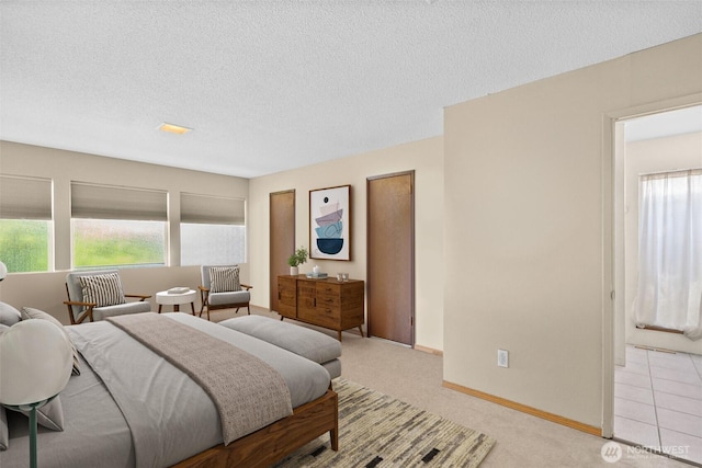 7618 19th St W, Tacoma, WA 98466 - bedroom with multiple windows, a textured ceiling, baseboards, and light carpet