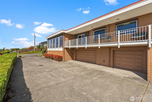 7618 19th St W, Tacoma, WA 98466 - view of side of property featuring stucco siding, an attached garage, and driveway