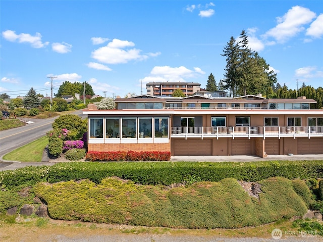 7618 19th St W, Tacoma, WA 98466 - rear view of house featuring an attached garage, a balcony, and driveway