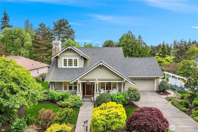 1241 Cherry Ave NE, Bainbridge Island, WA 98110 - view of front facade featuring covered porch, a garage, roof with shingles, and a chimney