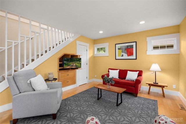 1241 Cherry Ave NE, Bainbridge Island, WA 98110 - living area with wood finished floors, baseboards, recessed lighting, and stairs