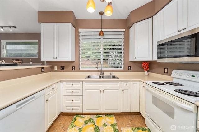 15150 140th Way SE Unit V104, Renton, WA 98058 - kitchen featuring white appliances, a sink, light tile patterned floors, and white cabinetry