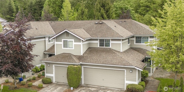 15150 140th Way SE Unit V104, Renton, WA 98058 - view of front of house featuring a shingled roof, a garage, driveway, and a forest view