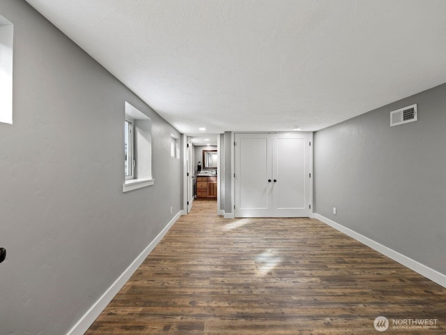 interior space with dark wood-style floors and baseboards