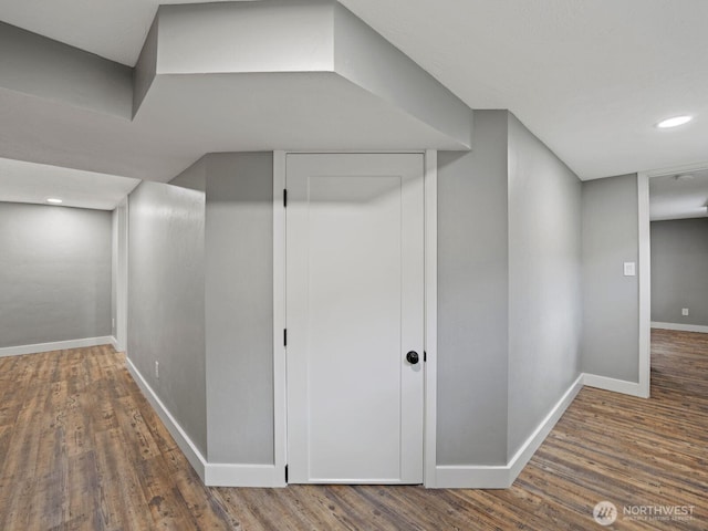 hallway with wood finished floors, baseboards, and recessed lighting