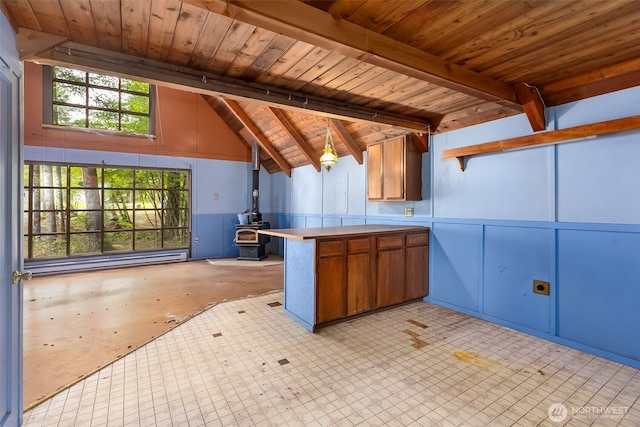 140 Sunstone Rd, Packwood, WA 98361 - kitchen with a wood stove, a peninsula, brown cabinetry, wood ceiling, and open shelves