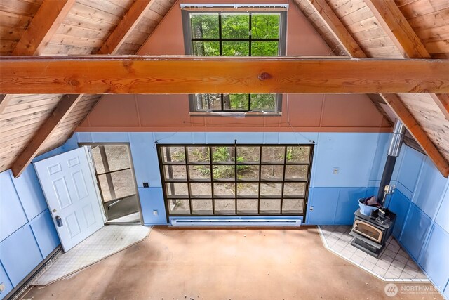 140 Sunstone Rd, Packwood, WA 98361 - unfurnished living room featuring wooden ceiling, a wood stove, and concrete flooring