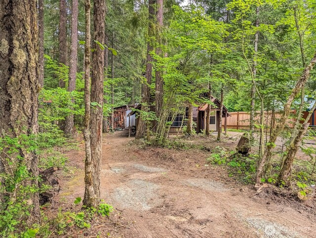 140 Sunstone Rd, Packwood, WA 98361 - view of yard featuring fence, a forest view, and an outbuilding