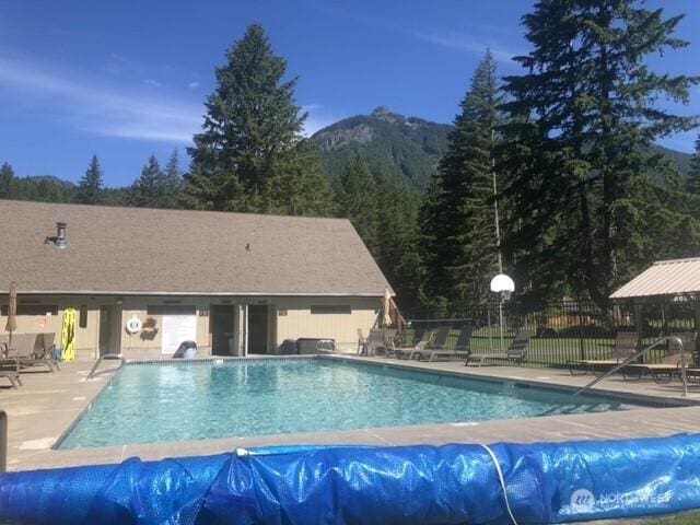 140 Sunstone Rd, Packwood, WA 98361 - community pool featuring fence, a mountain view, and a patio