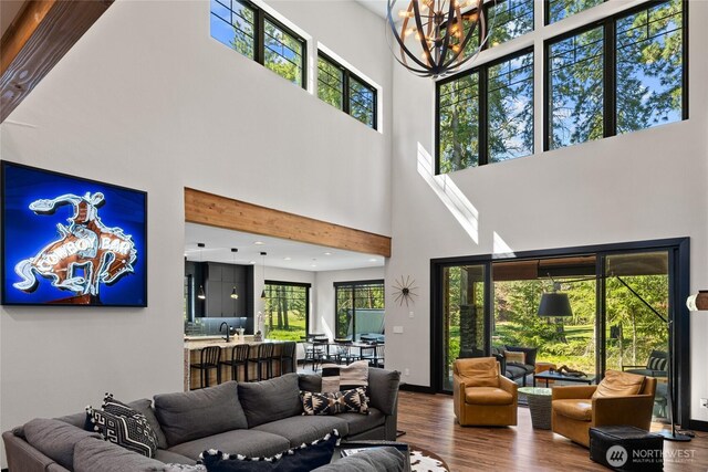 1591 Coal Mine Way, Cle Elum, WA 98922 - living room featuring a high ceiling, wood finished floors, a chandelier, and baseboards