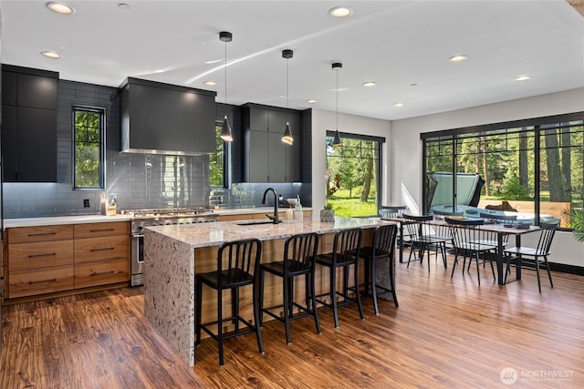 1591 Coal Mine Way, Cle Elum, WA 98922 - kitchen featuring wall chimney range hood, high end stainless steel range, a sink, modern cabinets, and recessed lighting