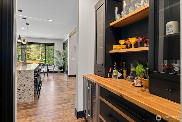1591 Coal Mine Way, Cle Elum, WA 98922 - indoor dry bar featuring wine cooler, wood finished floors, hanging light fixtures, baseboards, and recessed lighting