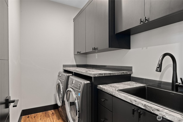 1591 Coal Mine Way, Cle Elum, WA 98922 - laundry area featuring cabinet space, washing machine and clothes dryer, wood finished floors, and baseboards