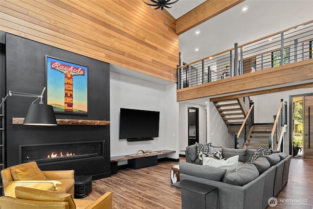 1591 Coal Mine Way, Cle Elum, WA 98922 - living area with a high ceiling, a large fireplace, wood finished floors, stairs, and wood walls