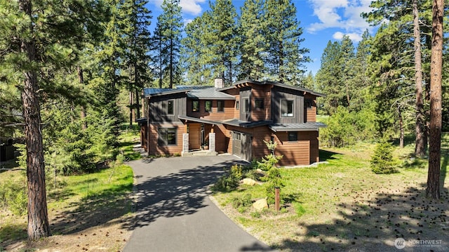 1591 Coal Mine Way, Cle Elum, WA 98922 - view of front facade featuring driveway, a garage, a standing seam roof, a chimney, and metal roof