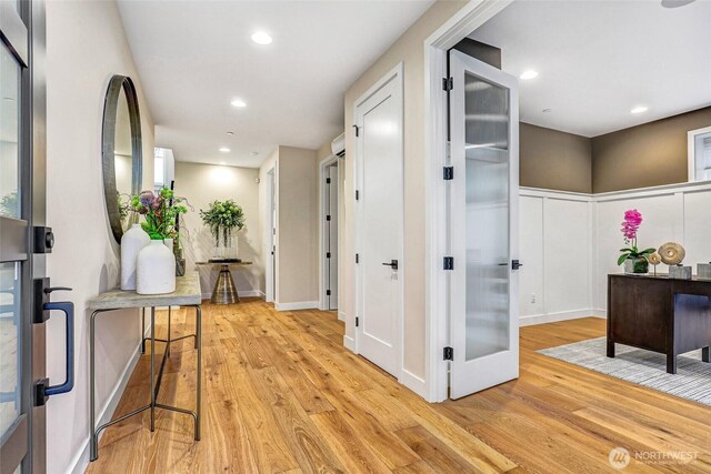 hall with light wood-type flooring and recessed lighting