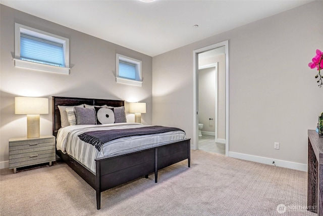 bedroom with carpet, baseboards, and ensuite bathroom