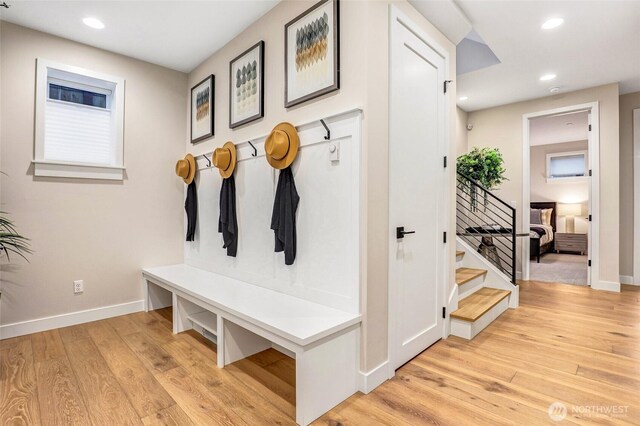 mudroom with light wood-style flooring, baseboards, and recessed lighting
