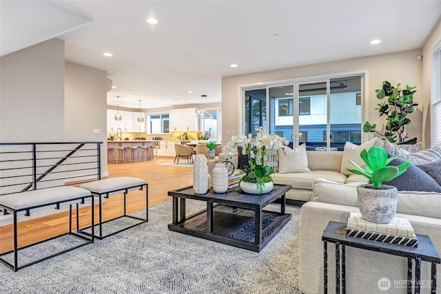 living area with recessed lighting and wood finished floors