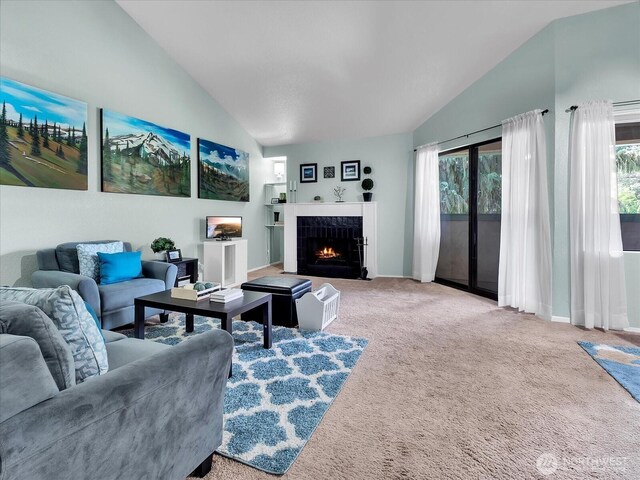 3024 NE 143rd St Unit 304, Seattle, WA 98125 - living area with lofted ceiling, carpet flooring, a tiled fireplace, and baseboards