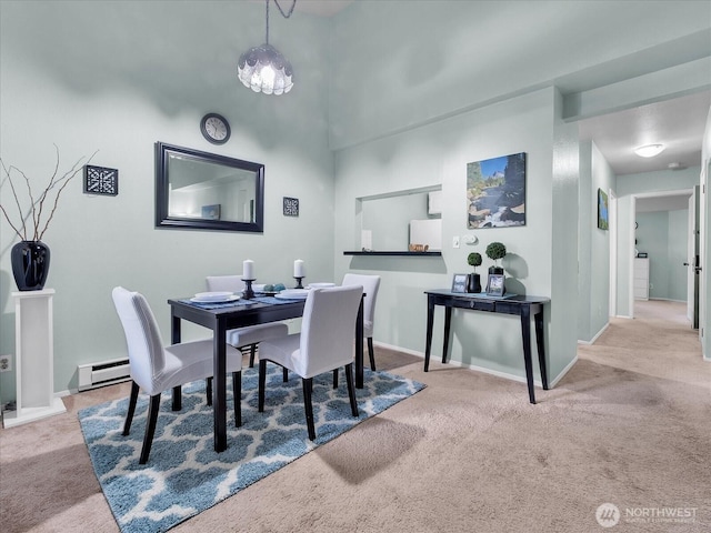 3024 NE 143rd St Unit 304, Seattle, WA 98125 - dining area featuring a baseboard radiator, carpet, and baseboards