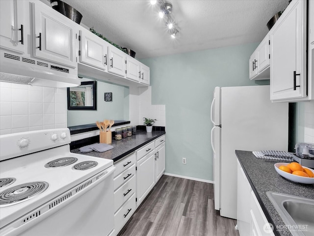3024 NE 143rd St Unit 304, Seattle, WA 98125 - kitchen with white appliances, under cabinet range hood, white cabinets, decorative backsplash, and dark wood-style floors