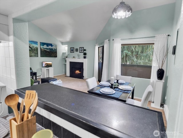 3024 NE 143rd St Unit 304, Seattle, WA 98125 - dining area with lofted ceiling and a fireplace with flush hearth