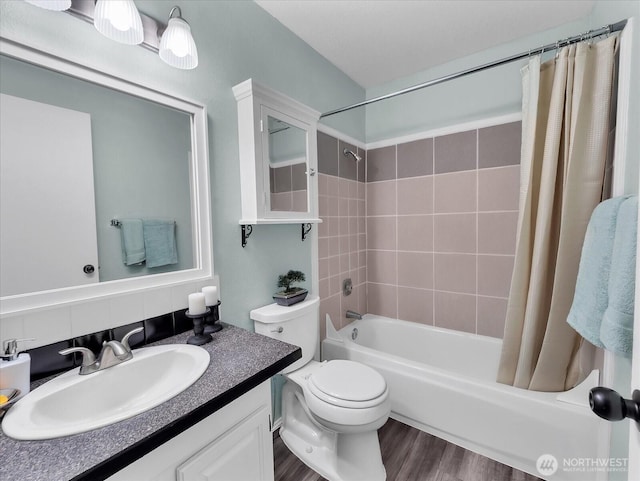 3024 NE 143rd St Unit 304, Seattle, WA 98125 - full bathroom with shower / bathtub combination with curtain, toilet, wood finished floors, vanity, and tasteful backsplash