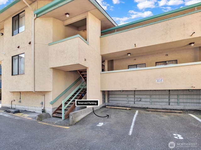 3024 NE 143rd St Unit 304, Seattle, WA 98125 - view of property with uncovered parking and stairway