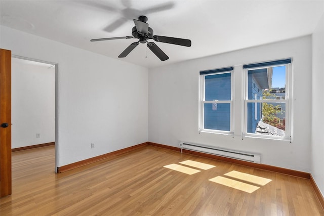 empty room featuring baseboard heating, light wood-style flooring, baseboards, and ceiling fan