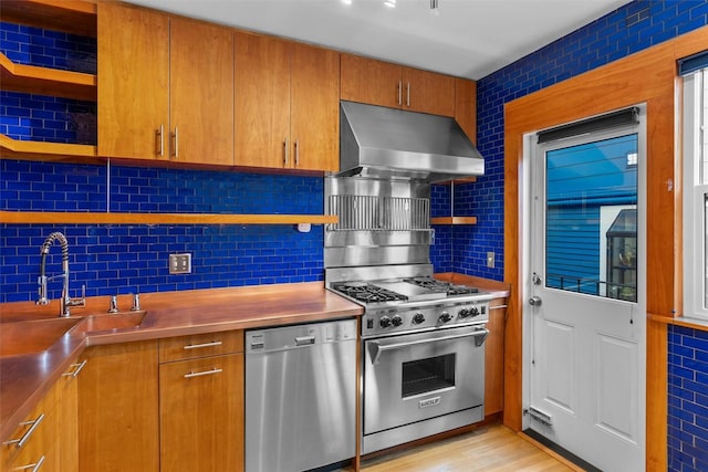 kitchen with open shelves, appliances with stainless steel finishes, stainless steel counters, under cabinet range hood, and decorative backsplash