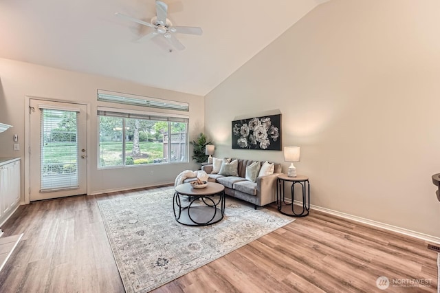 4313 S 220th Pl Unit 18-2, Kent, WA 98032 - living area featuring wood finished floors, a ceiling fan, baseboards, and high vaulted ceiling
